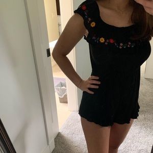A silky black romper with flower design